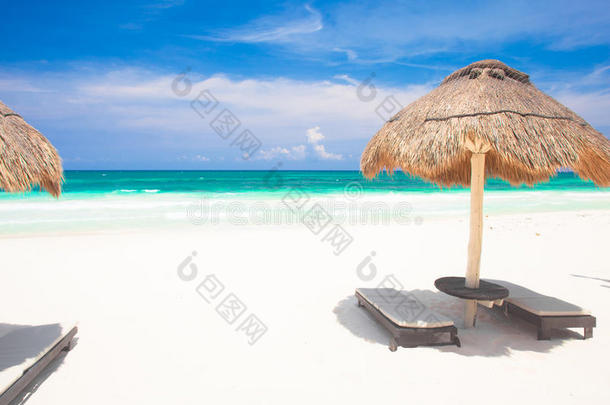 沙滩上的沙滩椅子和雨伞。 假日