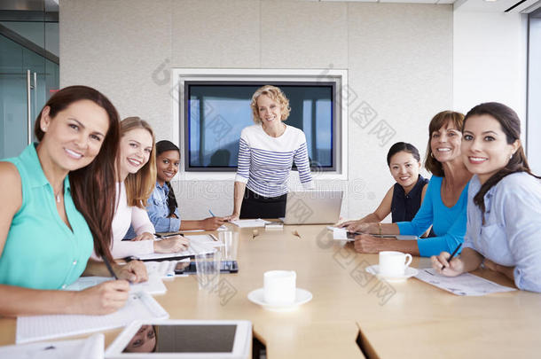 一群女商人围着董事会的桌子开会