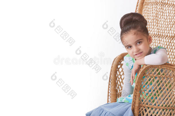 女孩摆在柳条椅上