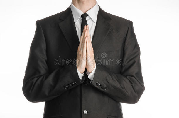 商人与手势<strong>话题</strong>：一个身穿黑色西装，打着领带的男人双手合十，祈祷、冥想
