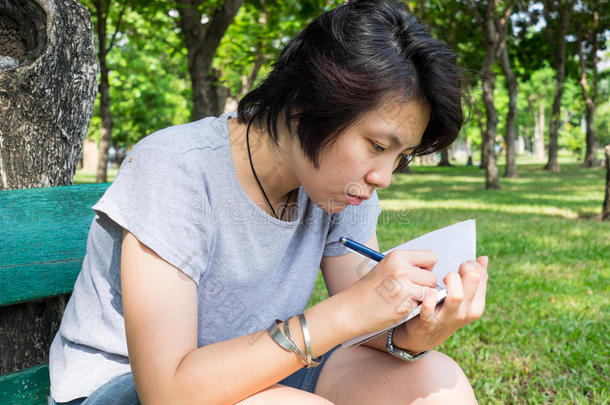 亚洲女人用钢笔和书记笔记