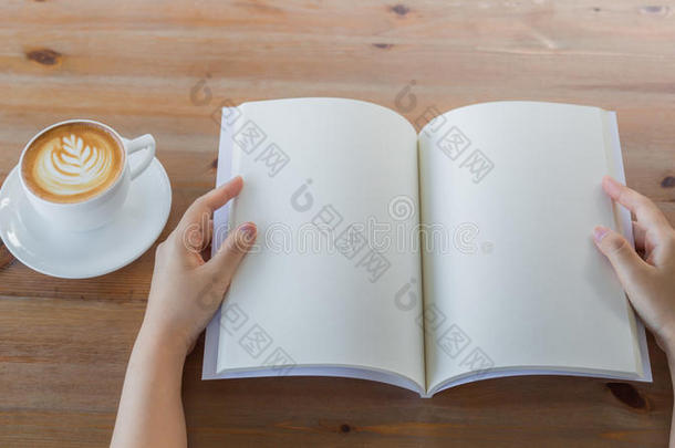 双手打开空白目录，杂志，书模拟在木桌上
