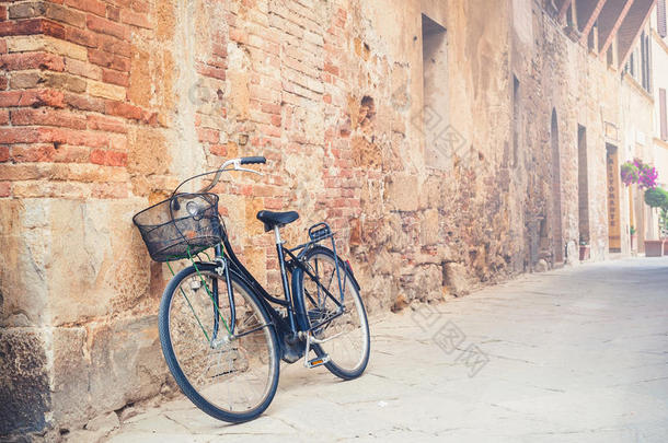 意大利托斯卡纳村一条街道上的黑色老式自行车