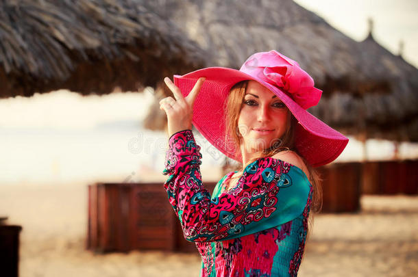戴着<strong>大红</strong>帽子的黑发女孩对着散焦的伞微笑