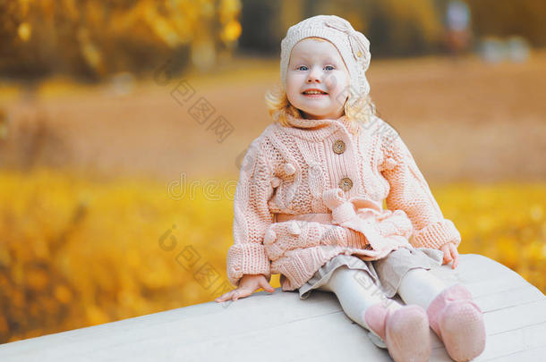 可爱的小孩子穿着针织的衣服，在秋天玩得很开心