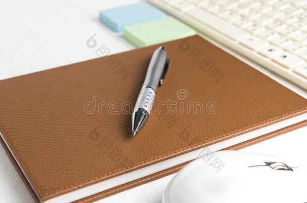电脑和带办公用品的棕色笔记本