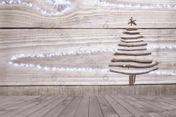 圣诞树是由空木甲板桌子上的棍子排列在闪闪发光的灰色背景上的。 准备好产品展示蒙太奇