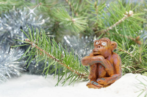 来自粘土陶器<strong>的梦幻</strong>般<strong>的</strong>快乐猴子坐在树附近<strong>的雪</strong>地里