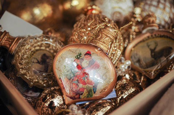 盒子里装满了金色的圣诞装饰品和带圣尼古拉斯图片的球