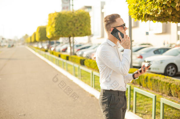 手里拿着手机和平板电脑的商人