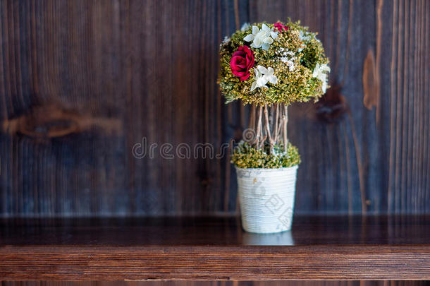盆景花瓶在架子上，木制架子上的花在内部