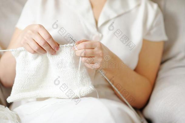 一个女人穿着白色羊毛针织物。