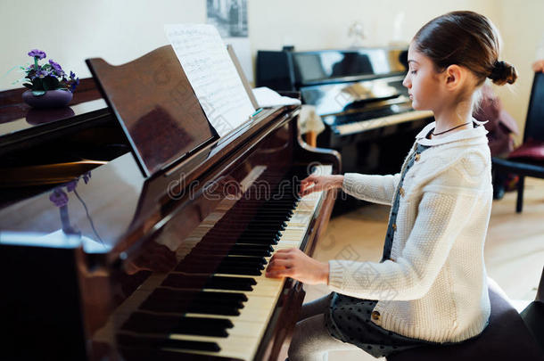 美丽的女学生在音乐<strong>学校</strong>弹<strong>钢琴</strong>