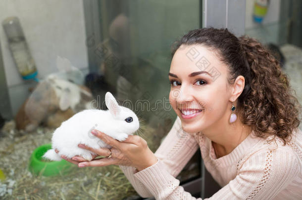 在<strong>宠物店</strong>抱着兔子的女孩