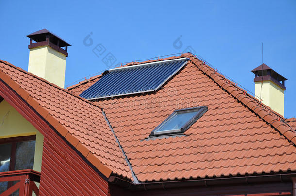 能源效率概念。 关闭太阳能电池板加热在红色瓷砖屋顶与防雷，天窗，