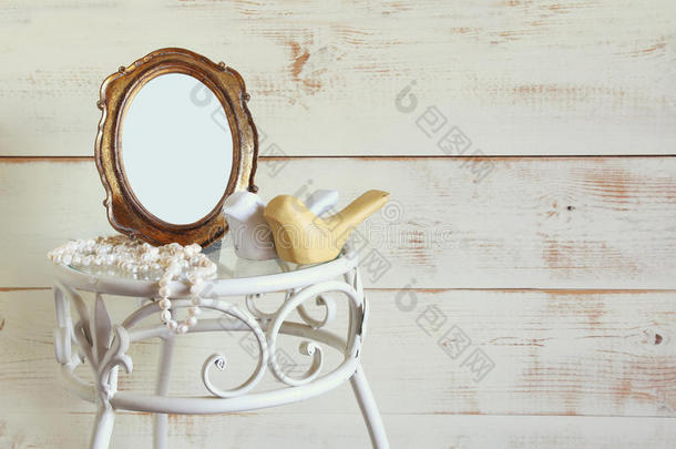 古董空白古董风格框架，白色珍珠和一对优雅的桌子上的木鸟。 模板，准备拍照