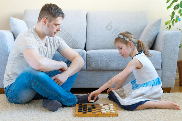 一家人在玩跳棋。