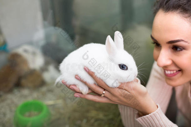 在宠物店抱着兔子的女孩