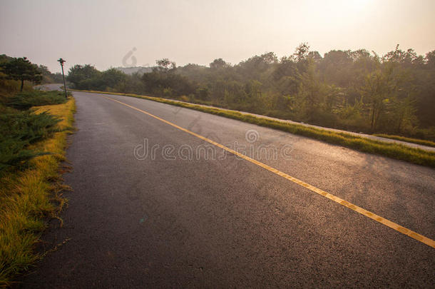 美丽的太阳升起的天空与沥青公路道路