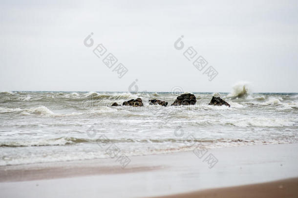 秋天的波罗的海海滩，云朵和波浪向着荒芜的沙丘飞去