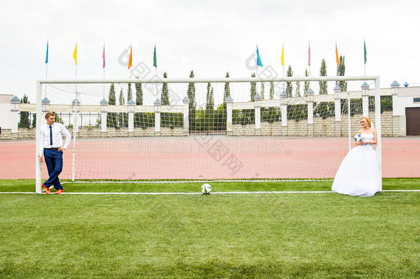 欧洲足球锦标赛的概念。 在足球场上的一对新婚夫妇。