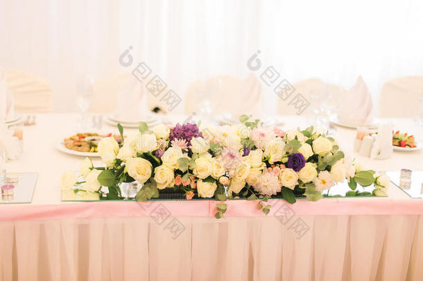 优雅地装饰着白色的花，眼镜和蜡烛餐厅庆祝婚礼