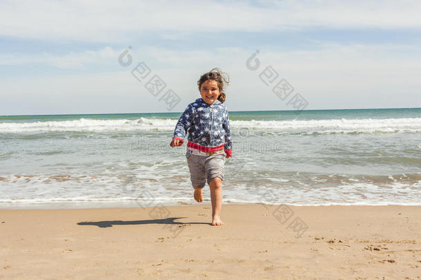 在一个阳光明媚的日子里，全镜头女孩在海滩上奔跑
