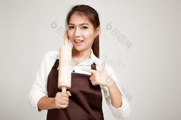 穿着围裙的亚洲面包师女人，带着<strong>木制滚</strong>针
