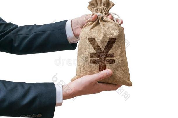 商人的手拿着装满钱的袋子和日元标志。