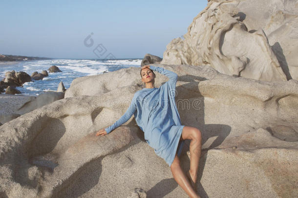 美丽的年轻女人在海上岩石中梦想放松，幻想c