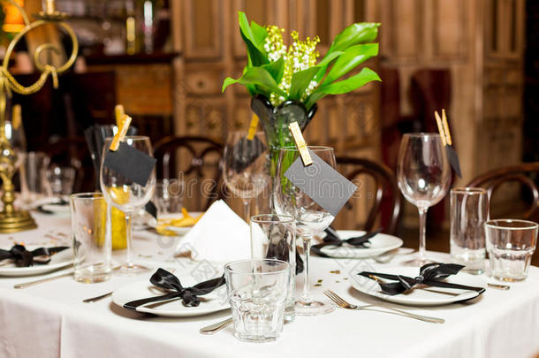 生日客人餐桌设置与新鲜的花黑色和金色风格，室内