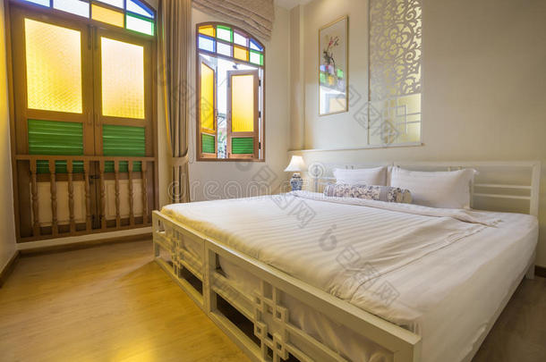 抽象卧室在温暖的浅色。 优雅的大舒适双人床
