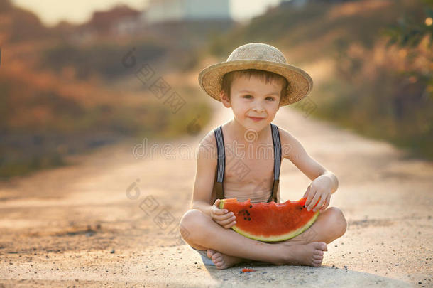 可爱的小男孩，在<strong>乡村小路</strong>上吃西瓜