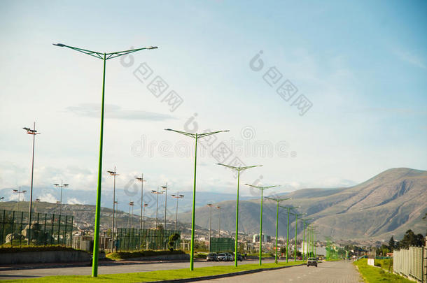 从高速公路的角度来看，伟大的景观显示了远处的山脉，绿色的<strong>灯柱</strong>和蓝天