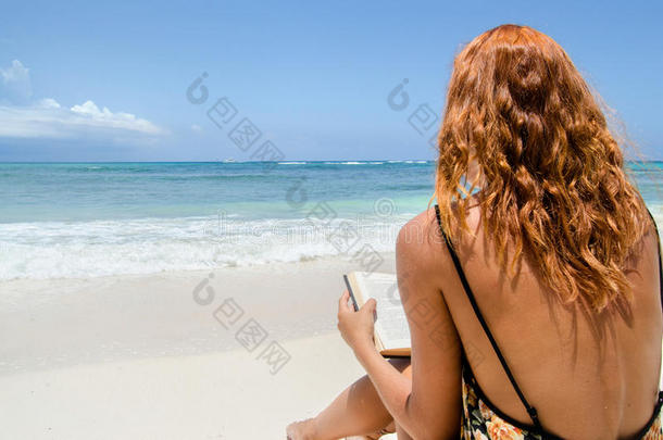 在海滩读书的女孩