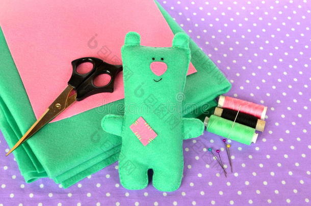 有趣的绿色毛毡泰迪熊，手工儿童玩具。 剪刀，线，针-缝纫装置