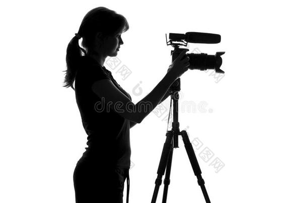 <strong>黑白剪影</strong>的女人站在视频设备旁边，并与它一起工作