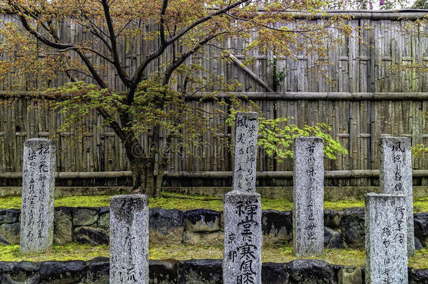 在樱花树上雕刻日本刻字花岗岩石柱