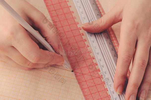 手工设计师在追踪纸上设计服装草图