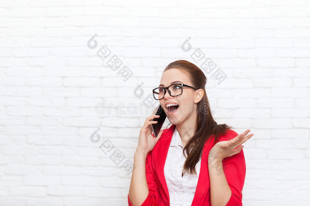 女商人高兴兴奋的手机通话，戴着红色夹克眼镜在手机上交谈