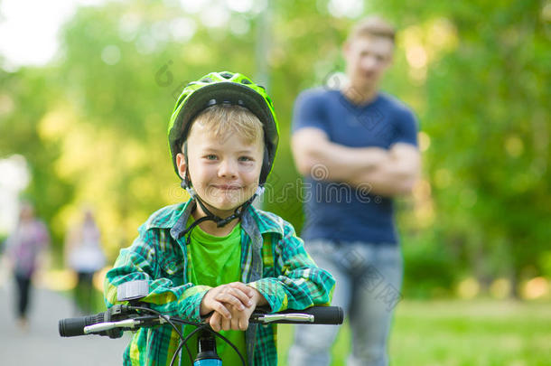 孩子骑自行车和父亲在公园里