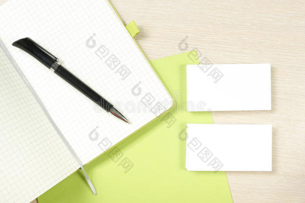 名片空白，记事本和钢笔在办公桌桌面视图。 企业文具品牌模型