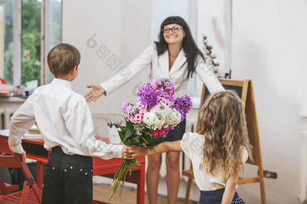 男孩和女孩在教师节给花当学校老师