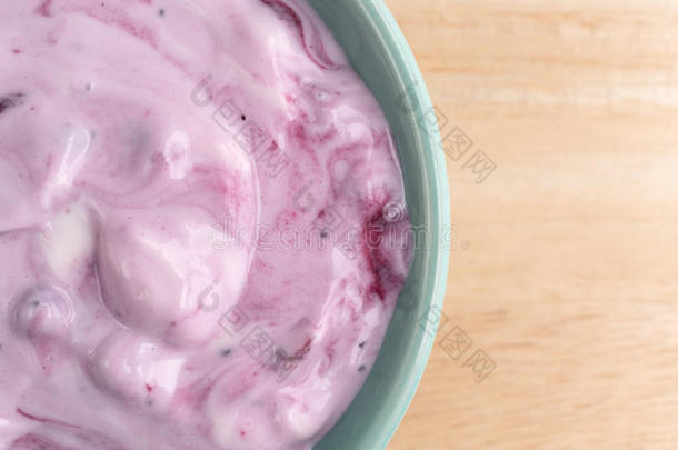 木桌上的一碗蓝莓美食酸奶