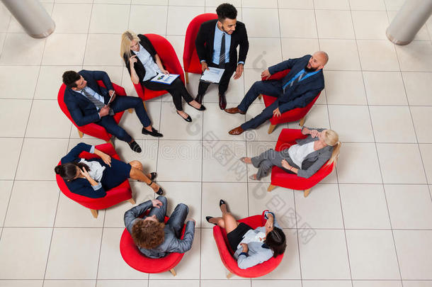 商务人士分组坐椅在圆圈顶部角度观看，商务人士会议