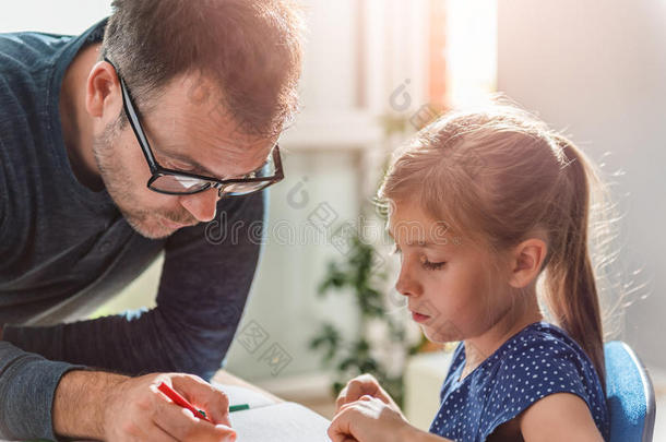 父亲帮助女儿完成家庭作业