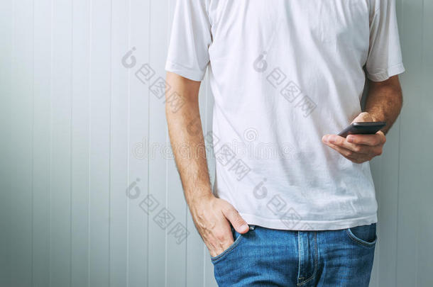 穿着白色T恤的休闲男士使用手机