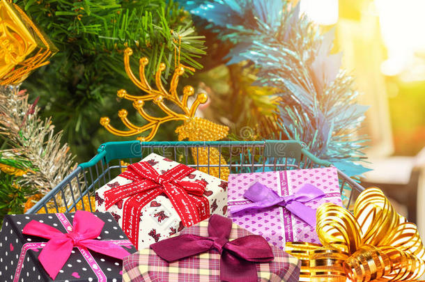 圣诞礼物和礼物在购物车与圣诞树装饰品