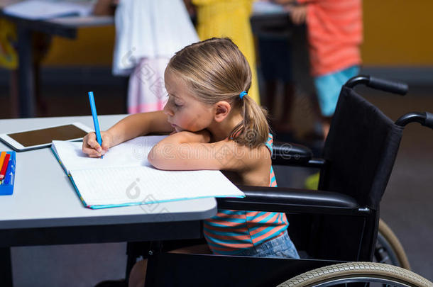 坐轮椅的女孩在书上写字