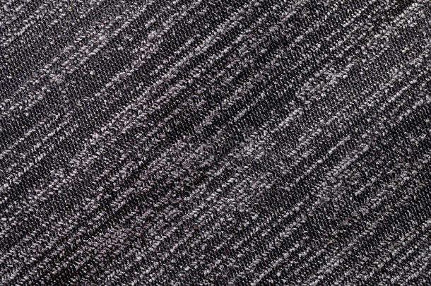针织纺织材料的黑白背景。 带有条纹纹理特写的织物。